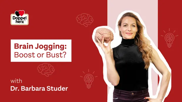 Image d'une femme tenant un cerveau en modèle, portant un haut noir. Le texte "Brain Jogging: Boost or Bust?" est affiché, accompagné du nom "Dr. Barbara Studer". Arrière-plan rouge avec des symboles d'idées. L'image traite des bienfaits ou non du "brain jogging".